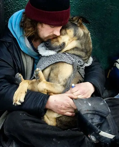 A man tenderly embracing his dog on the street